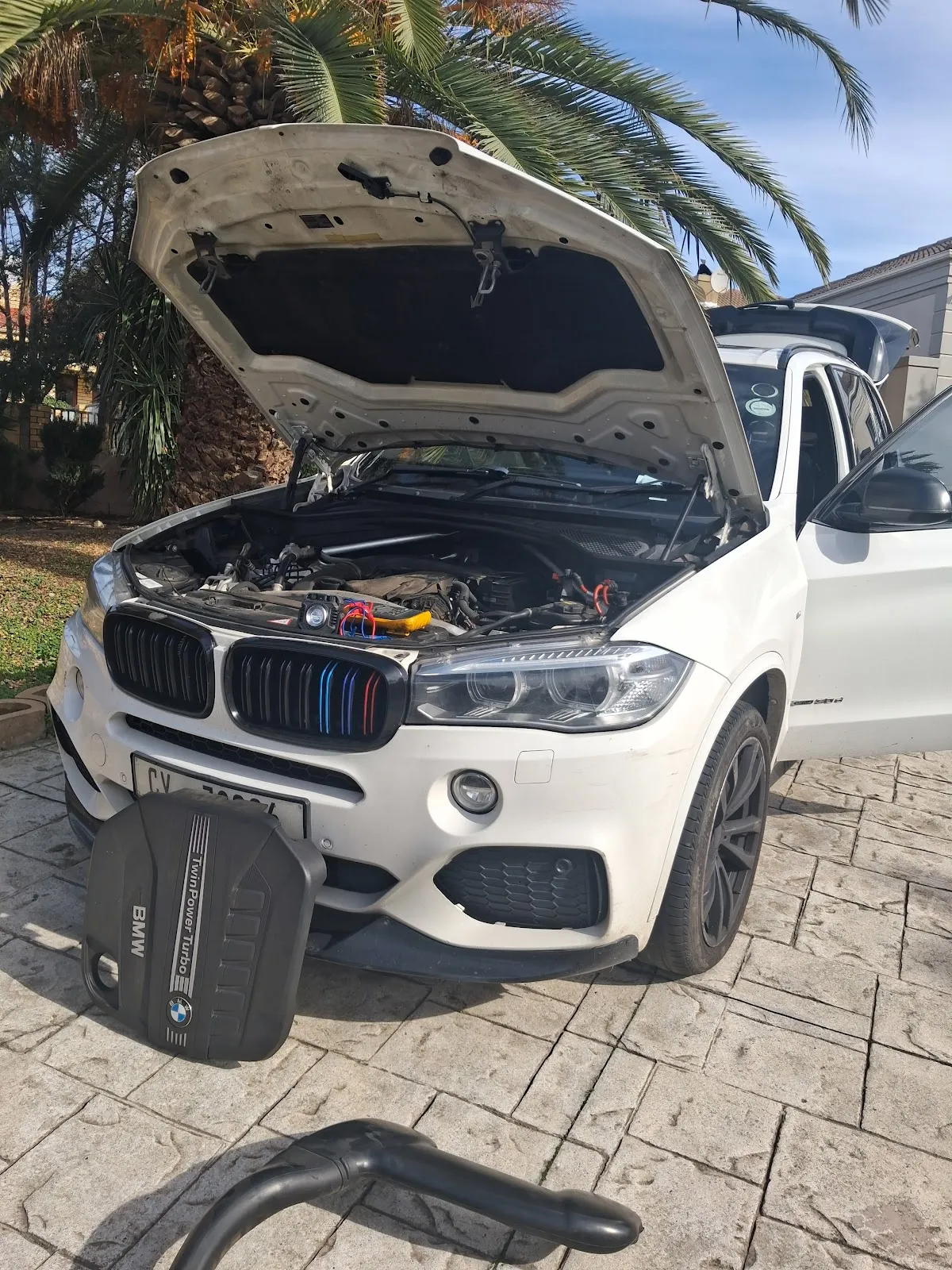 BMW X5 on-site engine service at customer driveway in Cape Town