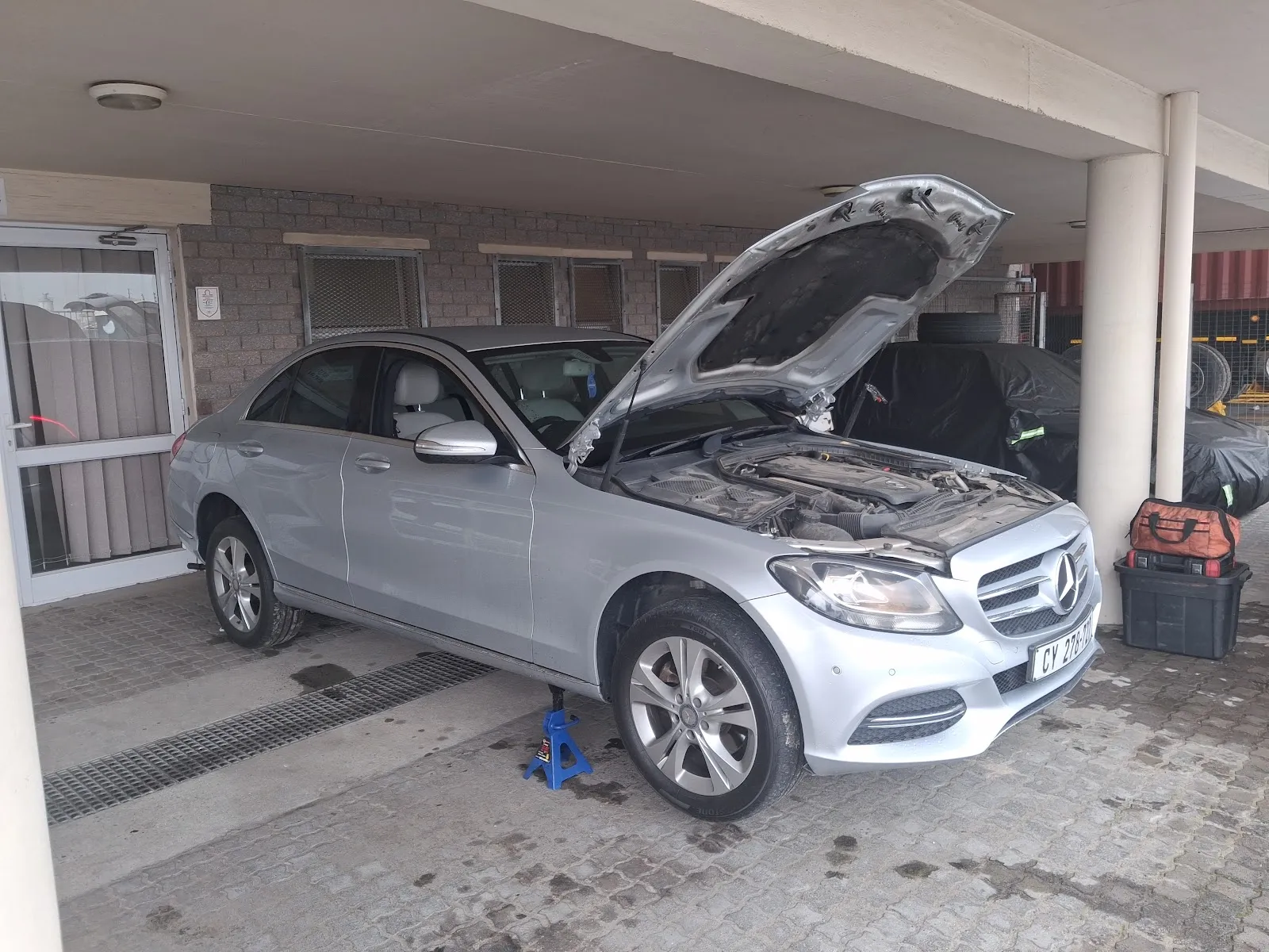 Mercedes C-Class raised on jack stands for on-site service in Cape Town